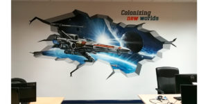 Graffiti trampantojo de nave X Wing de Star Wars en oficina